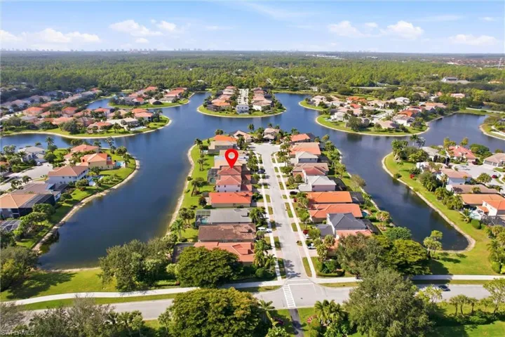 Aerial perspective of suburban area with a nearby body of water