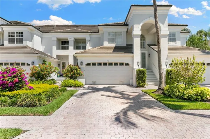 Mediterranean-inspired architecture with white stucco exterior and tile roofing