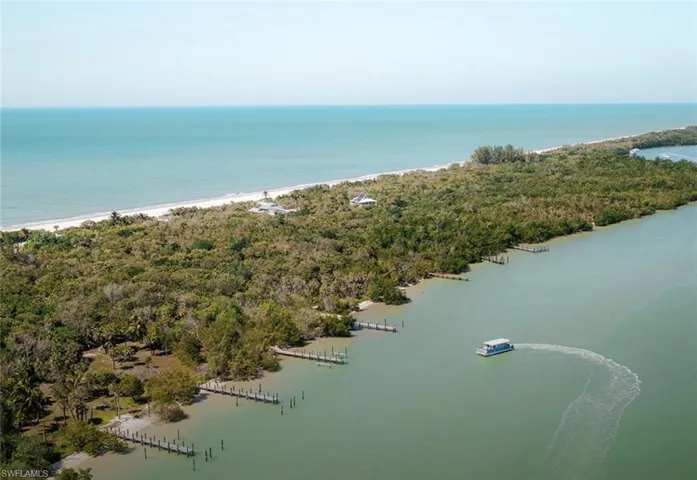 Coastal property featuring extensive natural landscaping, multiple private docks, and direct Gulf access