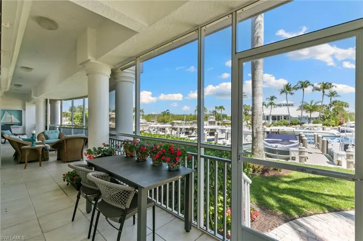 Screened-in patio with tile flooring and stately columns