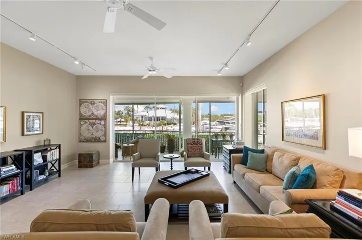 Spacious living area featuring neutral-toned walls and large format tile flooring