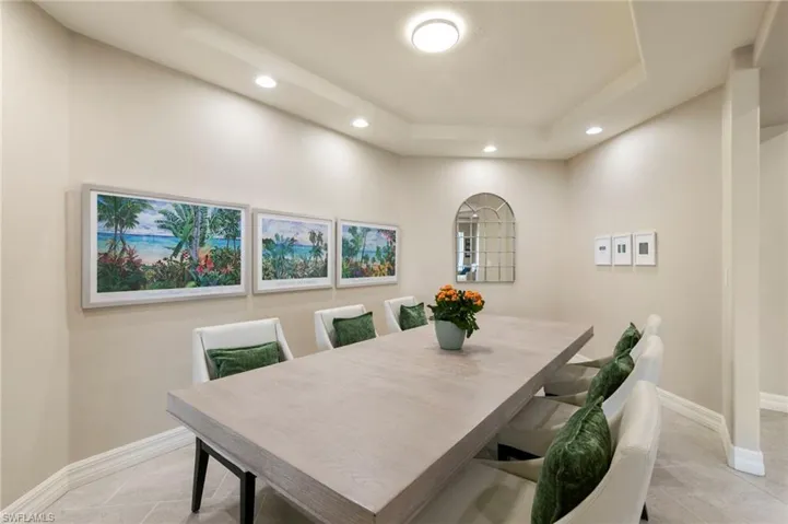 Tray ceiling with recessed lighting and a central flush-mount fixture