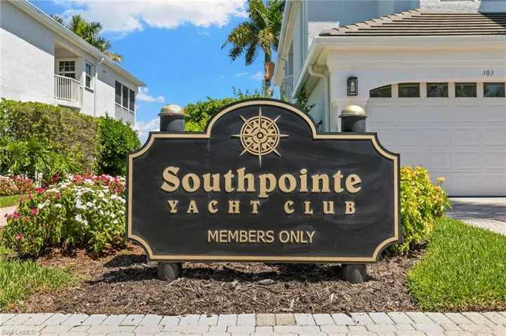 Southpointe Yacht Club members-only signage with gold-tone lettering and compass detail, set amidst manicured landscaping