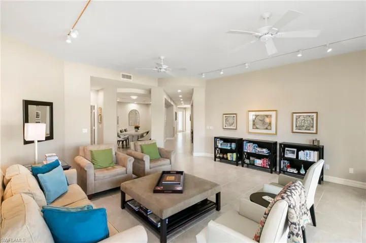 Spacious living area featuring tile flooring, neutral wall tones, and recessed lighting