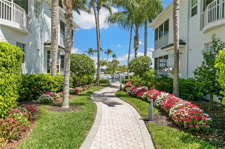 Brick paver pathway winding through lush landscaping