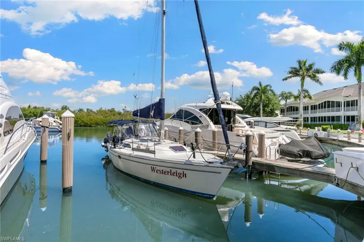 Docked boats in a marina with clear blue waters