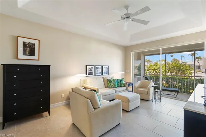 Spacious living area featuring neutral-toned walls and large format tile flooring