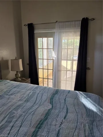 Bedroom French door out to the screened porch