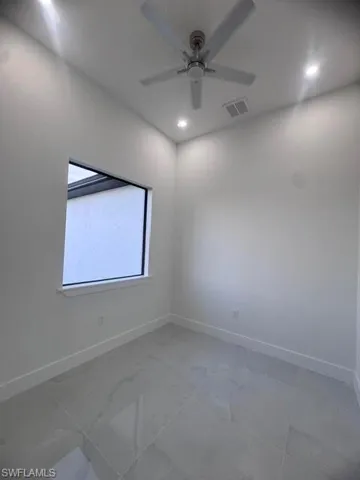 Room featuring large format tile flooring, a contemporary ceiling fan, recessed lighting, baseboards, and a window with a white trim