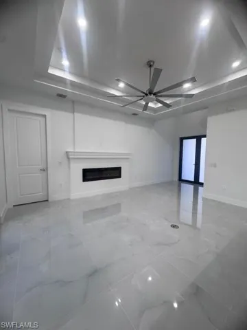 Spacious living area featuring large format polished tile flooring