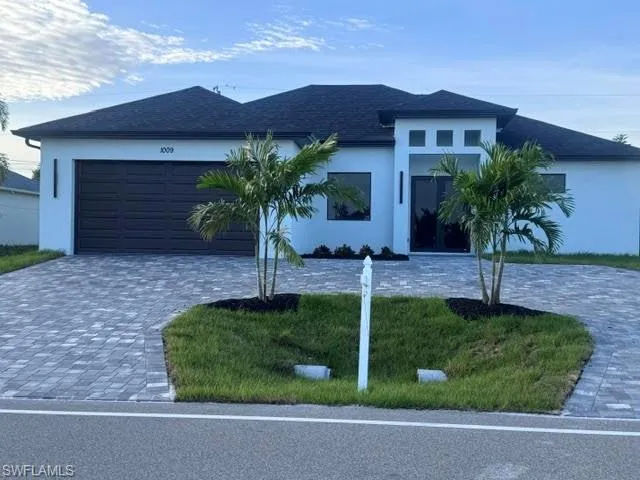 Contemporary white stucco exterior with a dark asphalt shingle roof