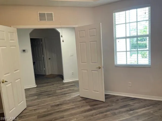 Large window and double door entry to den.