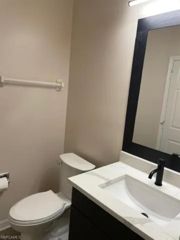 Half bath with vanity and comfort height toilet.