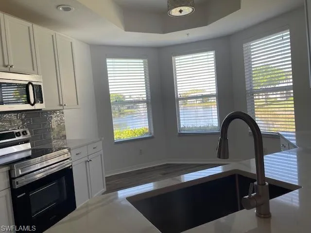 Newly painted cabinets, quartz counters, SS sink.