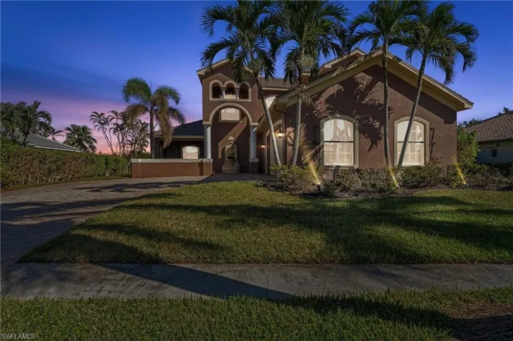 Mediterranean / spanish home with a lawn