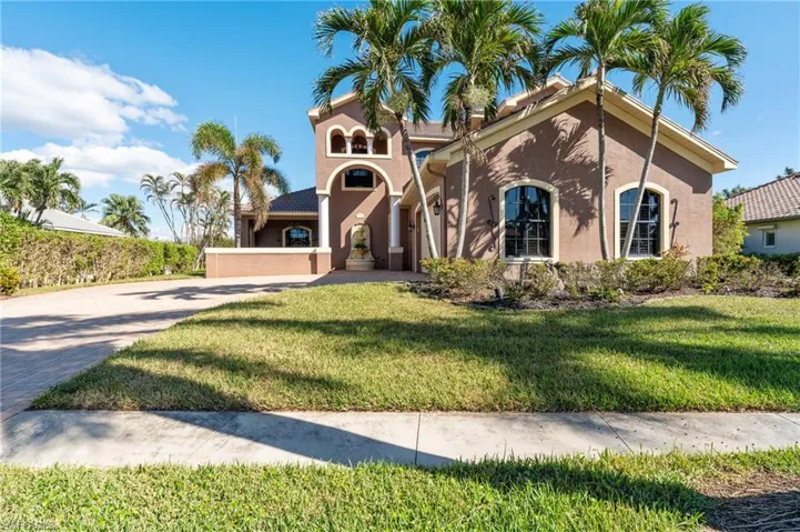 Mediterranean / spanish home with a front yard