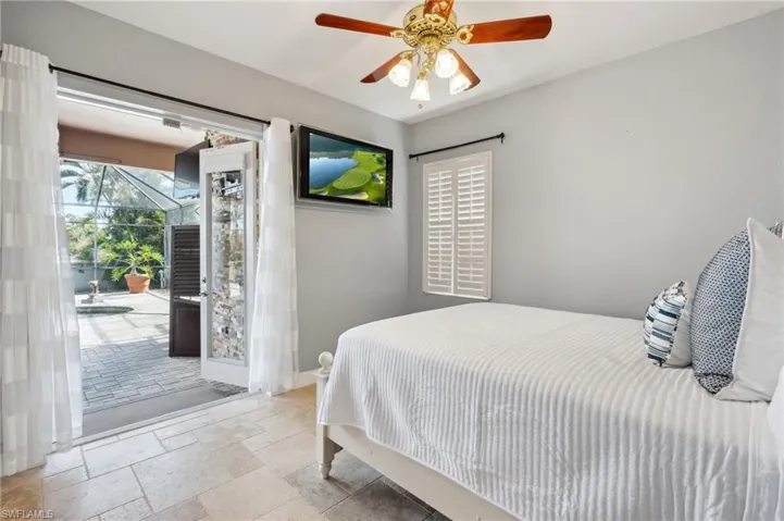 Bedroom featuring ceiling fan and access to exterior