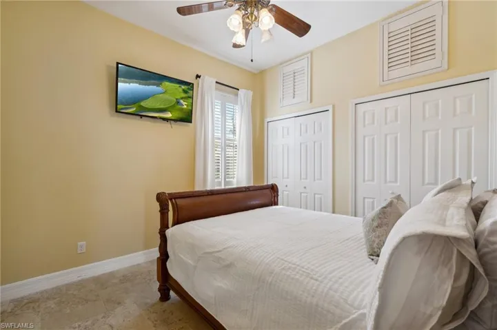 Bedroom with multiple closets and ceiling fan
