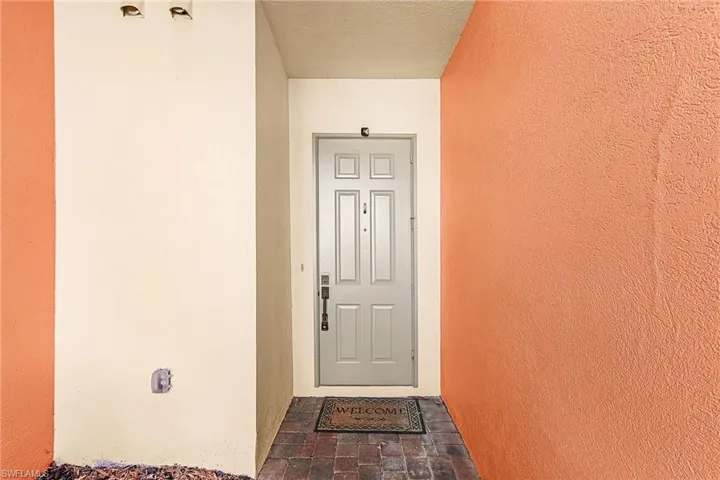 View of exterior entry with stucco siding