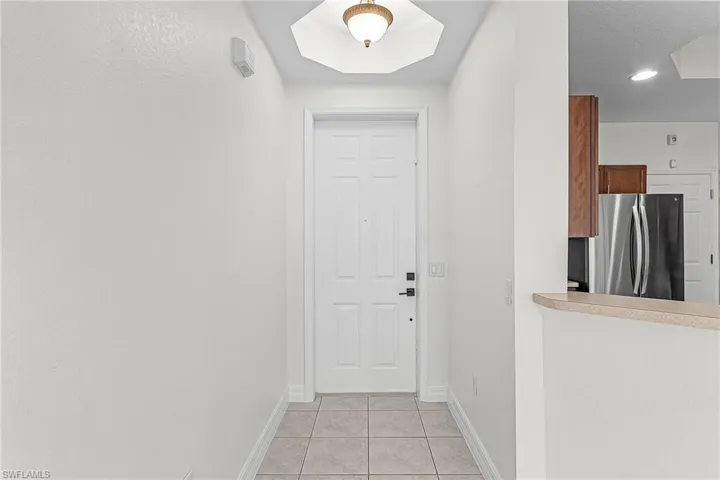 Entryway with baseboards and tile patterned flooring
