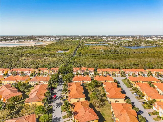 Aerial perspective of suburban area with a nearby body of water