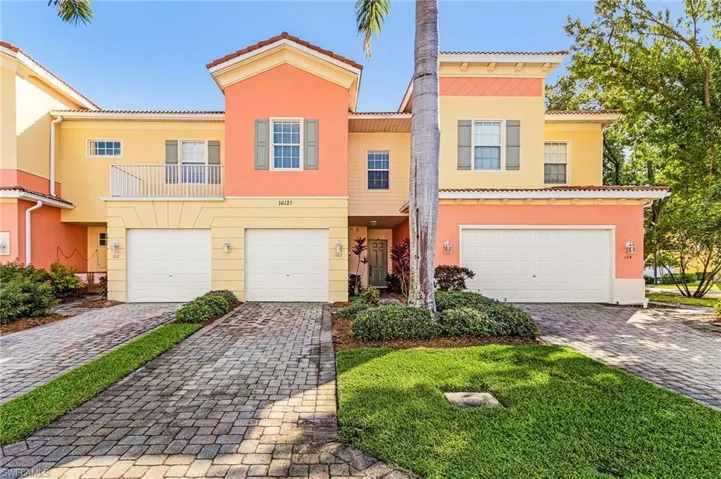 Mediterranean / spanish-style house with a garage, a balcony, and driveway