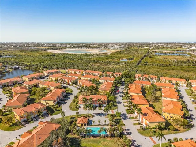 Aerial perspective of suburban area featuring a nearby body of water