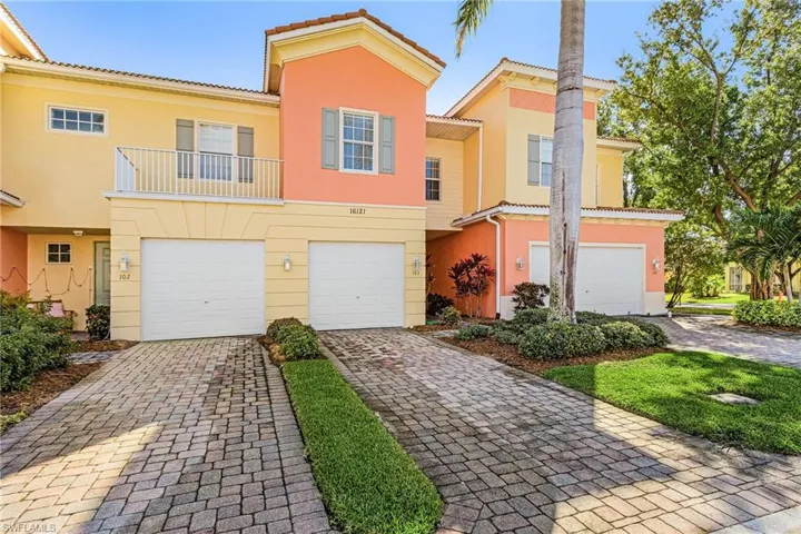 Mediterranean / spanish-style home featuring a balcony, a garage, a tile roof, driveway, and stucco siding