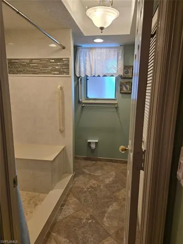 Full bath with a stall shower and a textured ceiling