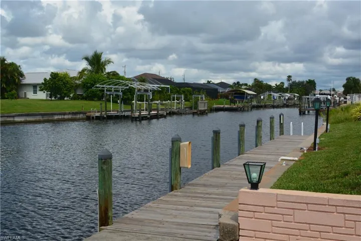 Dock with a water view and a residential view