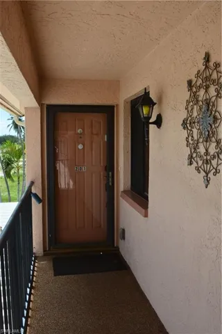 View of exterior entry featuring stucco siding