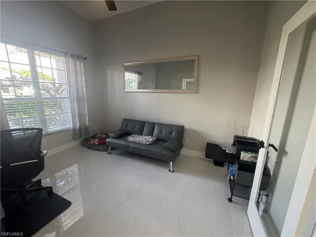 Home office featuring baseboards and a ceiling fan