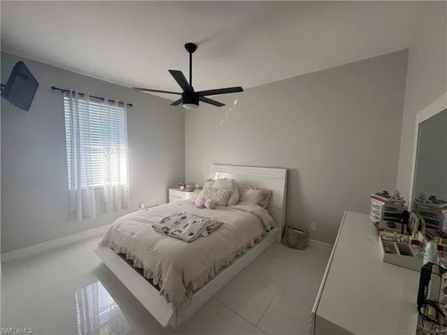 Bedroom featuring ceiling fan and baseboards