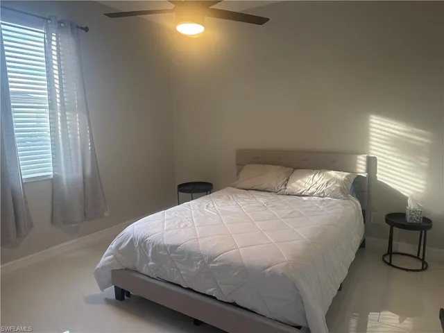 Bedroom with baseboards and a ceiling fan