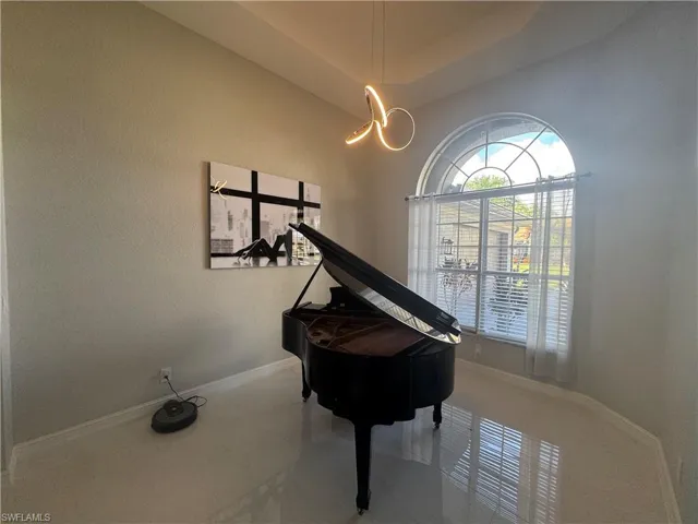 Sitting room with baseboards and a raised ceiling