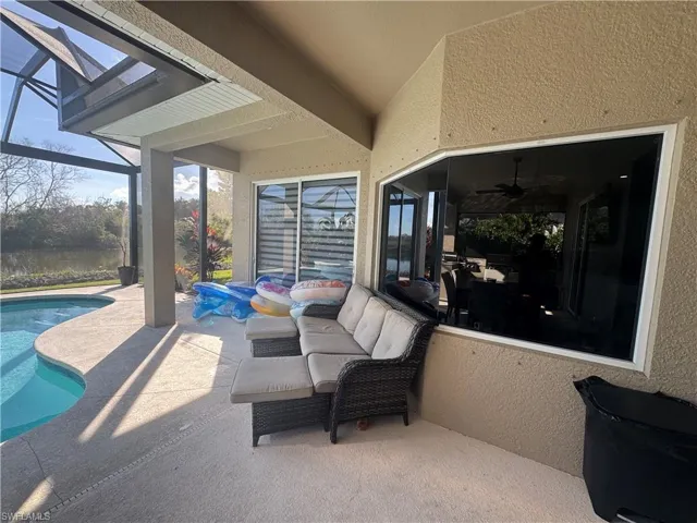 View of patio / terrace featuring an outdoor pool, a lanai, and a sunroom