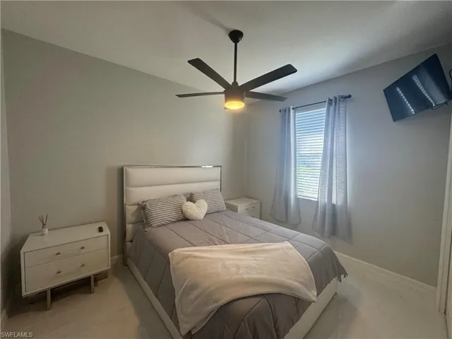 Bedroom with ceiling fan and carpet floors