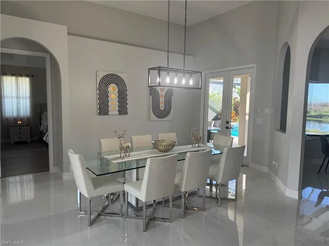 Dining area with arched walkways and french doors
