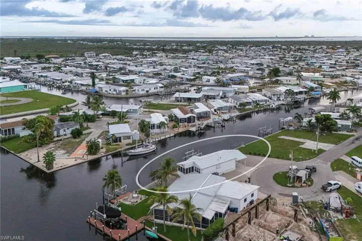 Aerial view of residential area featuring a nearby body of water