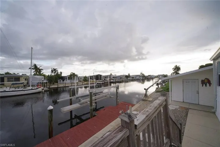 Dock area with a water view and boat lift