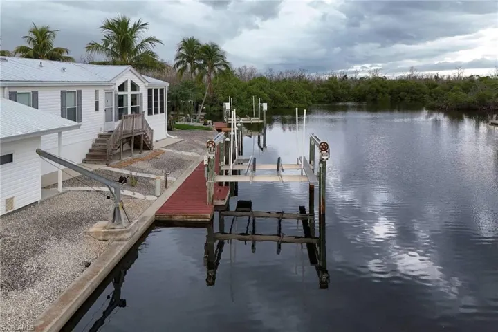 Dock featuring boat lift and a water view