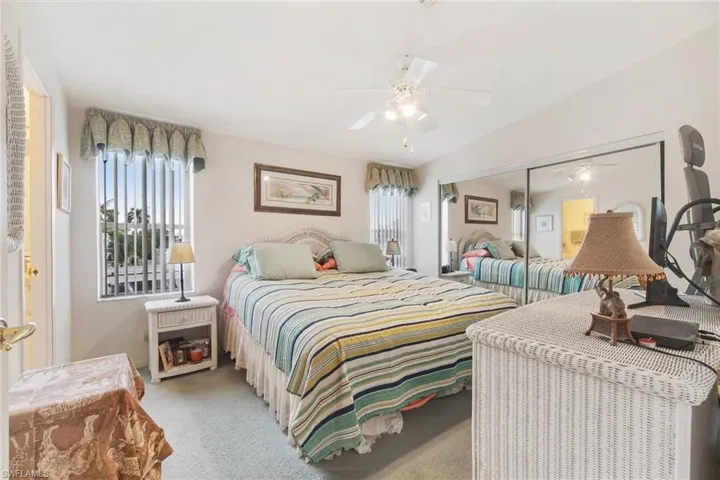 Bedroom with carpet floors, a closet, and ceiling fan