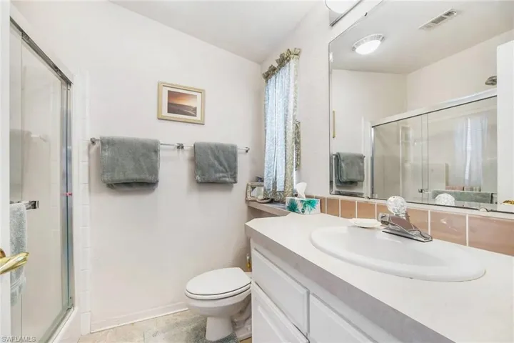 Bathroom with vanity and a stall shower