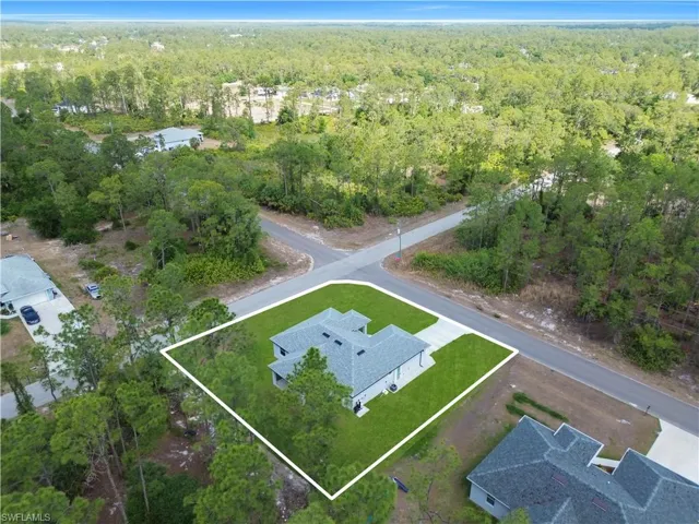 Aerial view of property's location featuring a heavily wooded area and property boundaries highlighted