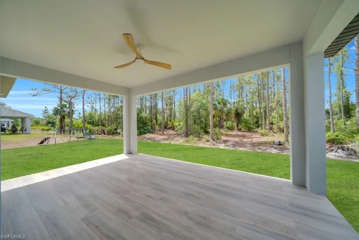 View of patio / terrace featuring a playground and a ceiling fan