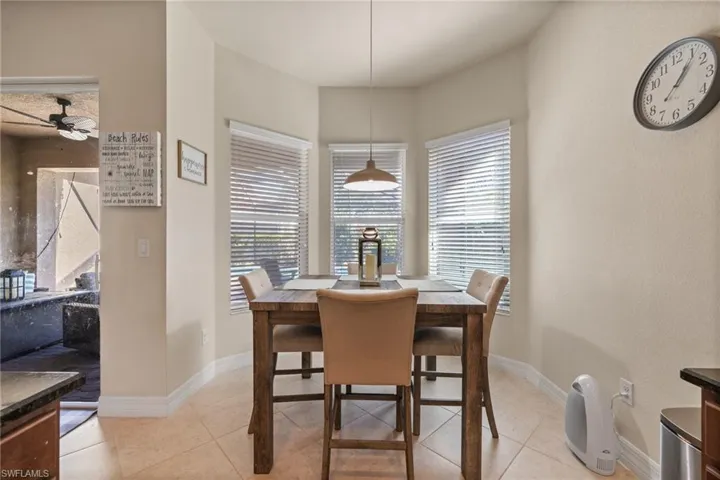 Tiled dining area featuring ceiling fan