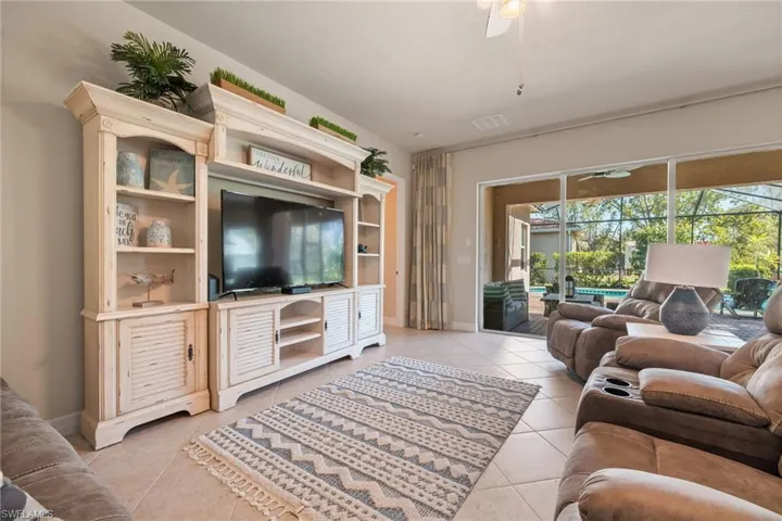 Tiled living room featuring ceiling fan