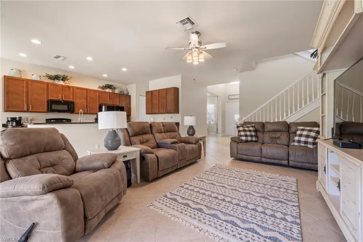 Tiled living room featuring ceiling fan