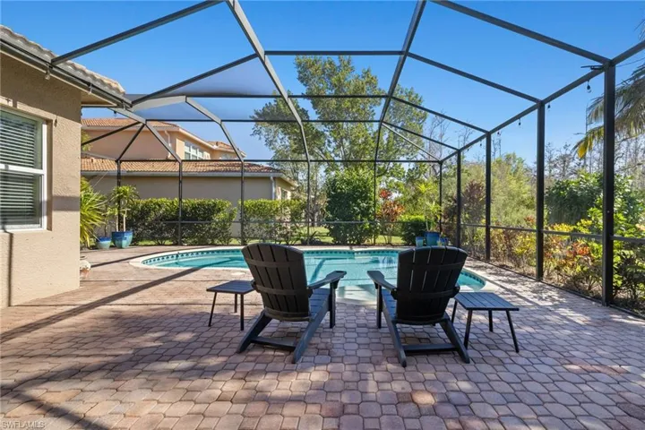 View of swimming pool with a patio area and screen enclosure