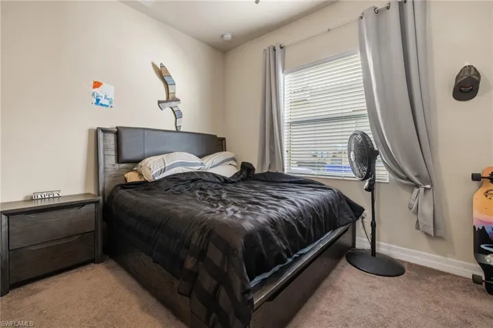 Bedroom featuring light carpet
